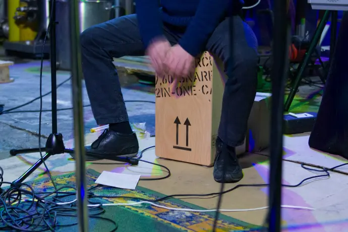 a man sitting on top of a wooden box
